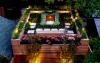 Illuminated roof garden with a pond at night